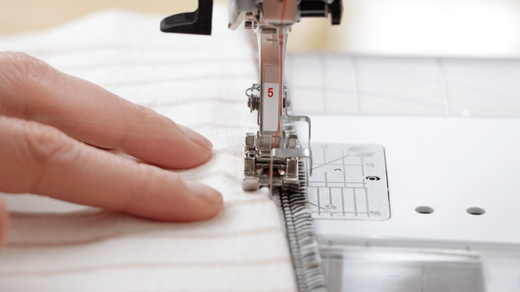 close-up of the blind hem stitch in progress, showing the needle catching just the fold