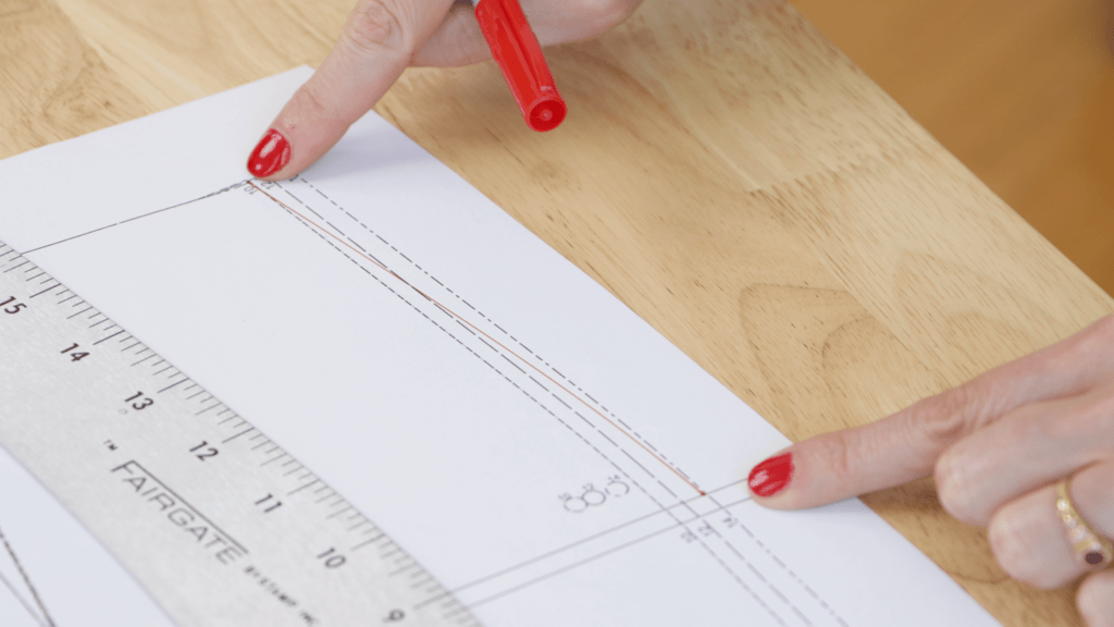 pattern paper showing size blending technique with curved line between size 10 waist and size 12 hip