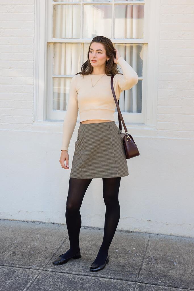woman modeling black and white Orla mini skirt
