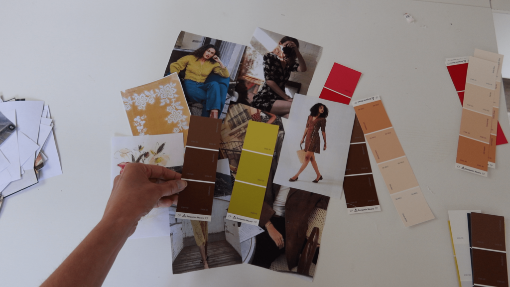 color palette swatches arranged on table showing olive-chartreuse, browns, ivory, black, and peach