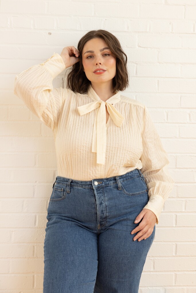 Woman wearing cream member bonus Garnet blouse