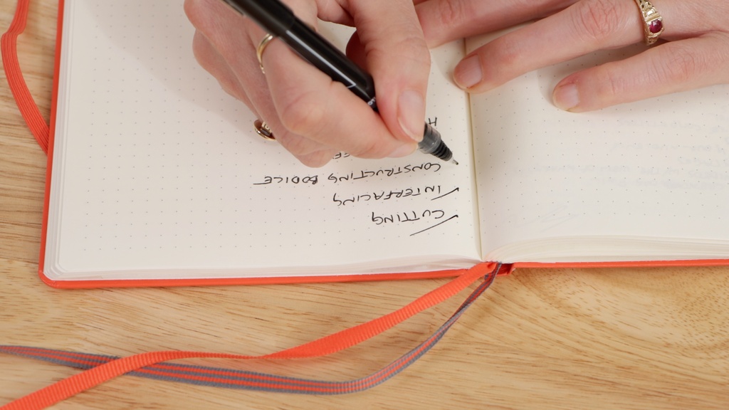 project notebook with detailed task list broken down into small steps