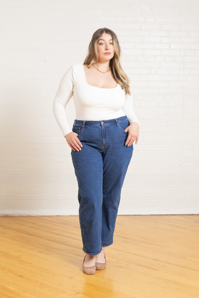 Woman wearing a white Ione bodysuit