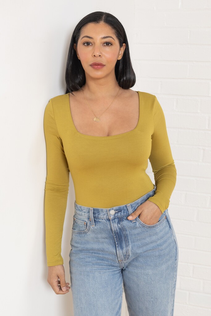 Woman modeling green Ione bodysuit