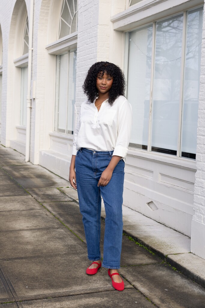 Model wearing a white Thyme shirt