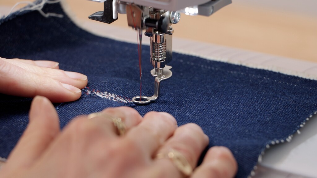 Close-up of darning foot in action, showing spring mechanism and fabric movement