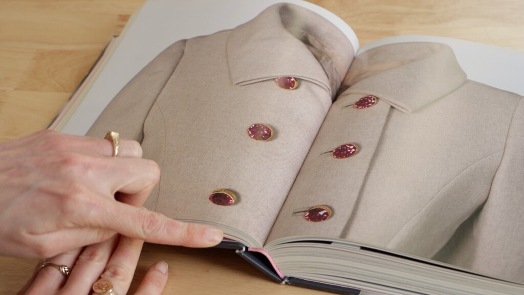 Coat showing oversized decorative buttons as focal point