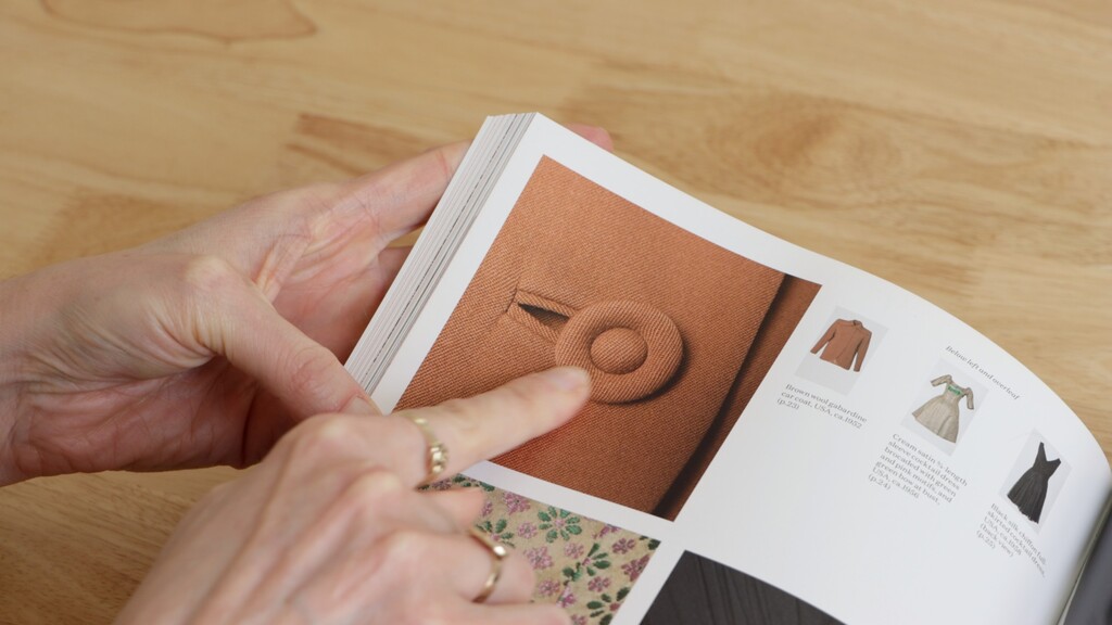 Close-up of bound buttonholes with covered buttons showing professional finish