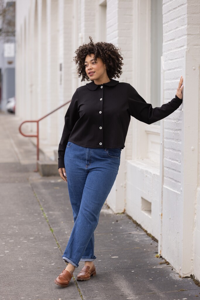 Woman modeling a black Thistle cardigan