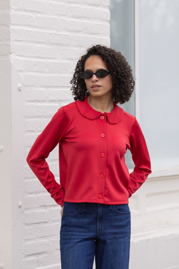 Woman modeling a red Thistle cardigan