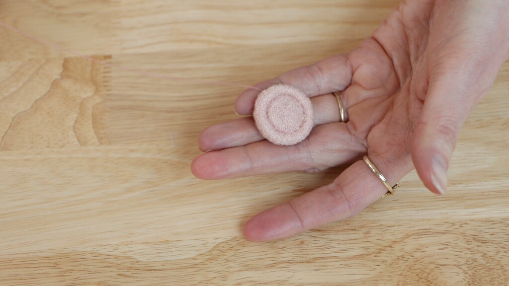 Completed Singleton button showing both front detail and back with thread shank attached