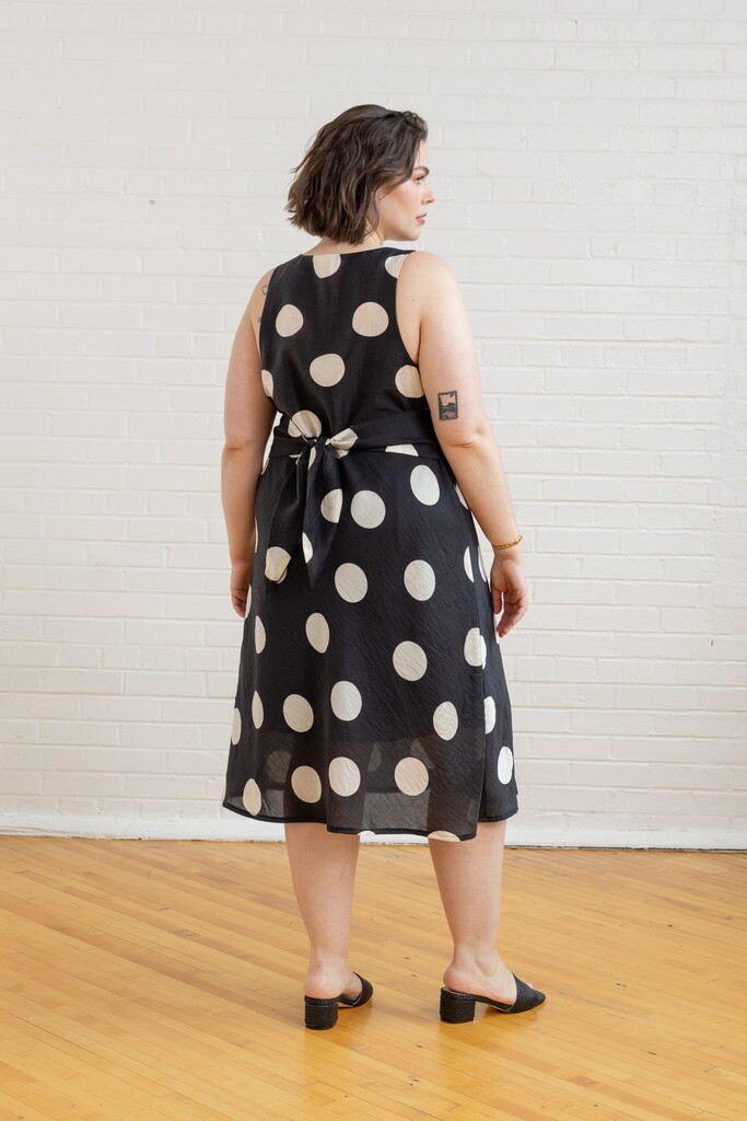 Model wearing polkadot Freesia dress in back view