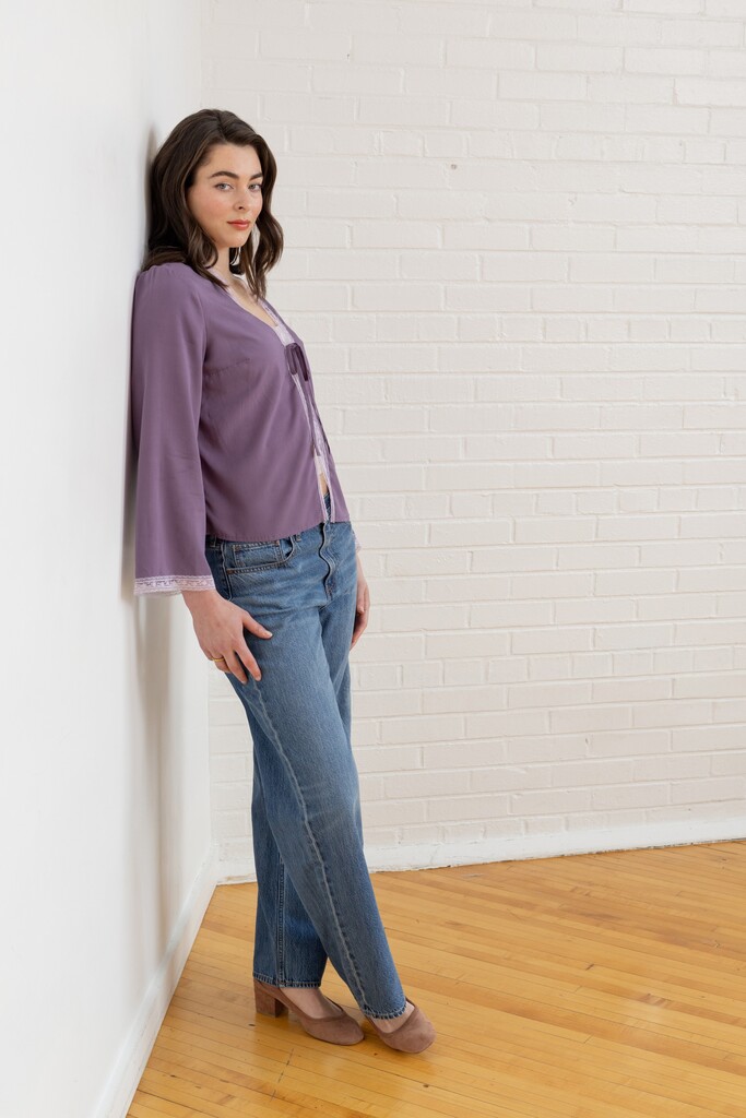 Model wearing violet Orchid bed jacket in side view