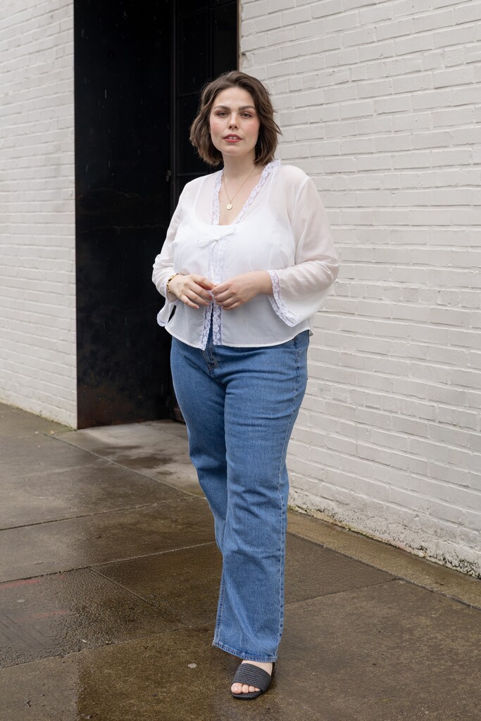 Woman modeling a white Orchid bed jacket