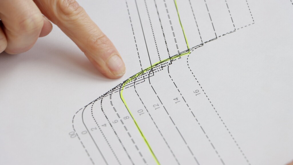 close-up of a pattern piece with bright yellow highlighting clearly marking one size line among multiple overlapping lines