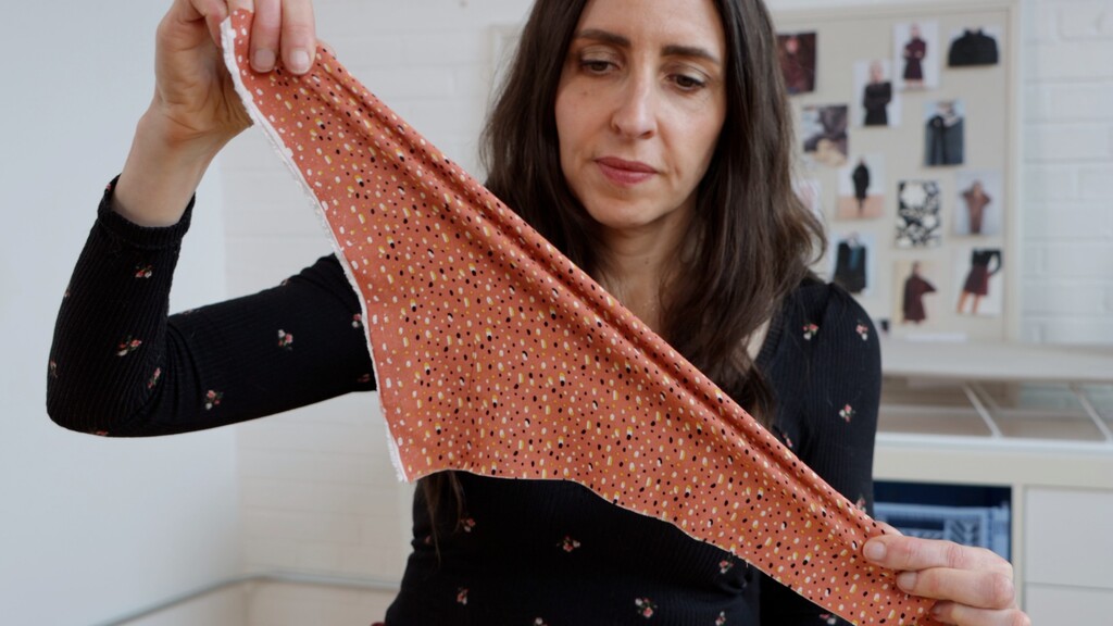 Detail shot of bias-cut fabric showing the fluid drape