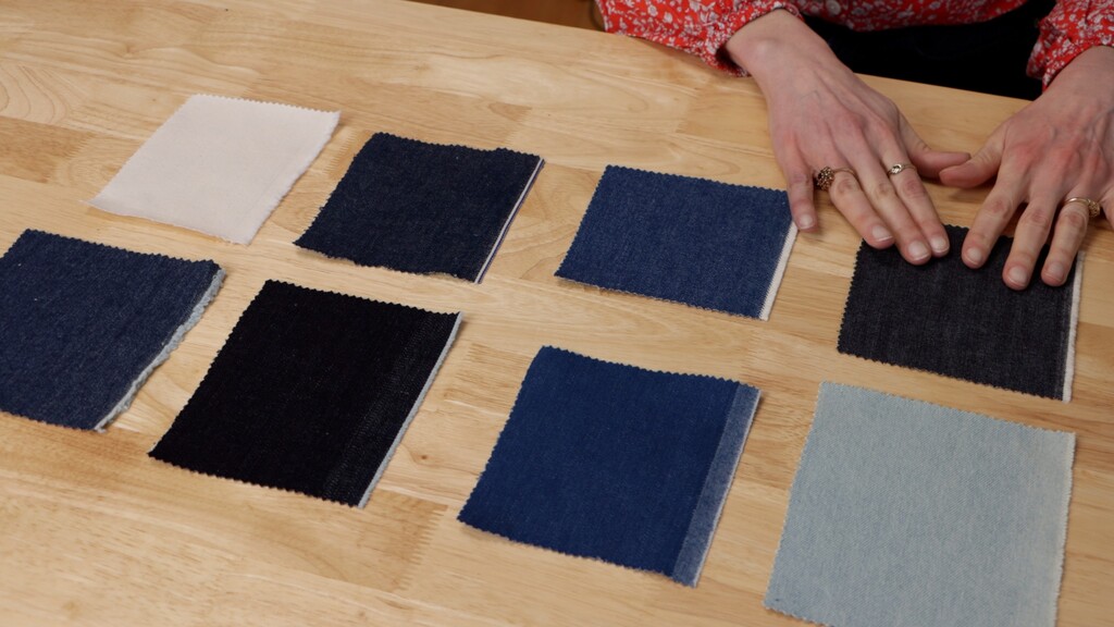 Various weights of denim fabric laid out showing different textures and colors