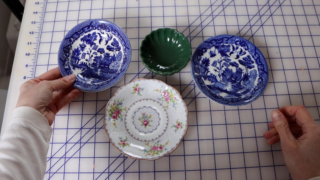 Small ceramic bowls and dishes repurposed to organize buttons, snaps, and other small notions