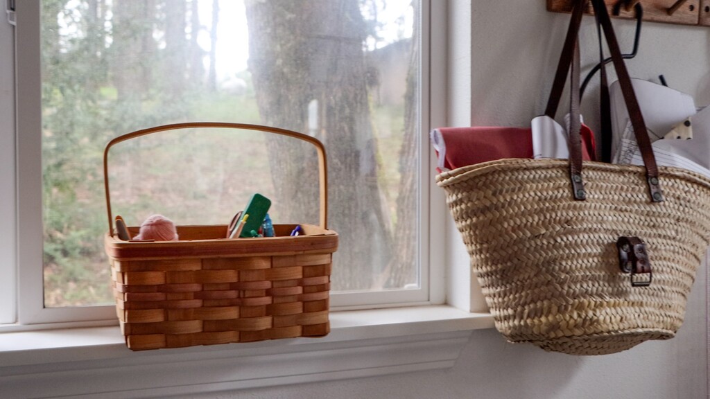 Collection of various sized thrift store baskets arranged on shelving