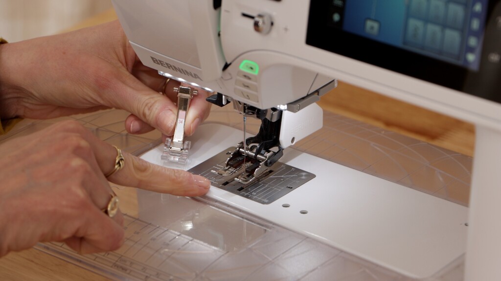 Sewing machine with walking foot attached, showing bias fabric being guided gently through