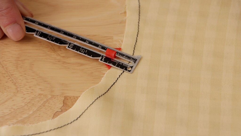 Close-up of staystitching along a bias-cut edge, showing the stitching line just inside the seam allowance