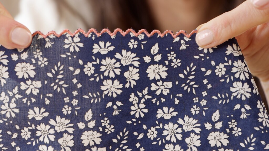 Detail shot of the finished scalloped neckline edge, pressed flat and showing clean, even scallop curves