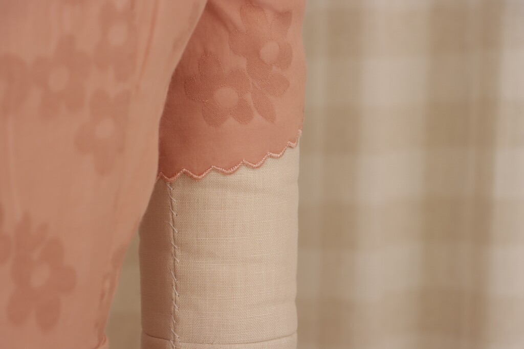 Detail shot of the sleeve hem with scalloped edge, showing how the technique works on a shorter, curved edge