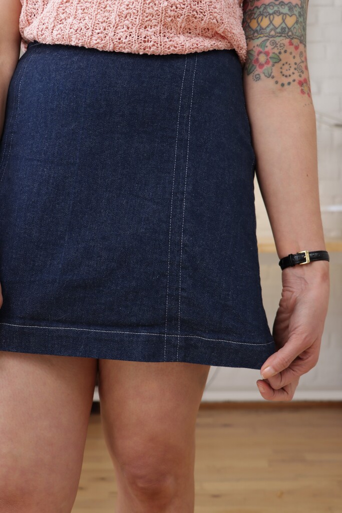 The Orla skirt in Japanese selvedge denim, showing the contrast white top-stitching detail