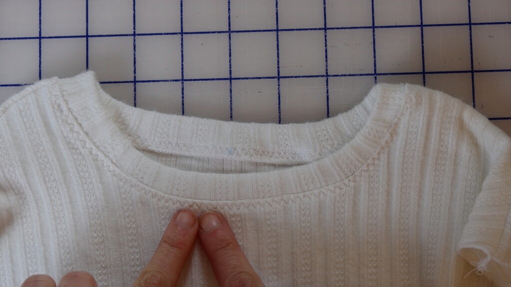 Finished neckband, topstitched, laid flat — showing a smooth, professional result