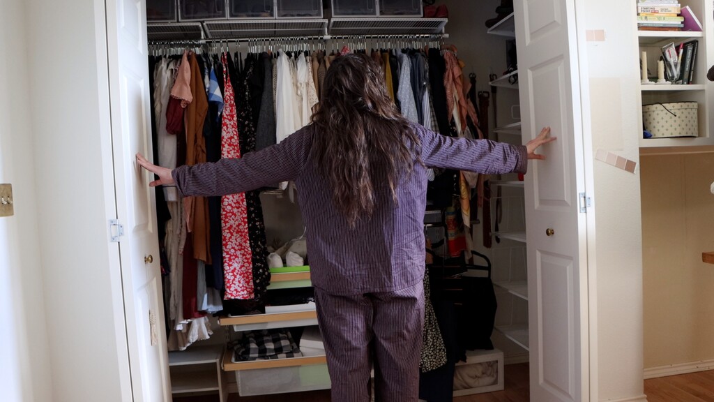 Sarai standing in front of wardrobe