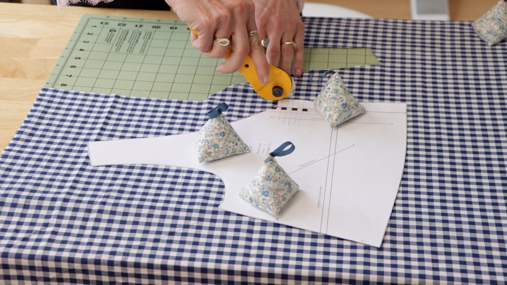 Overhead shot of a full pattern piece traced out as a mirrored flat piece, placed on checked fabric showing clear visibility of the check alignment
