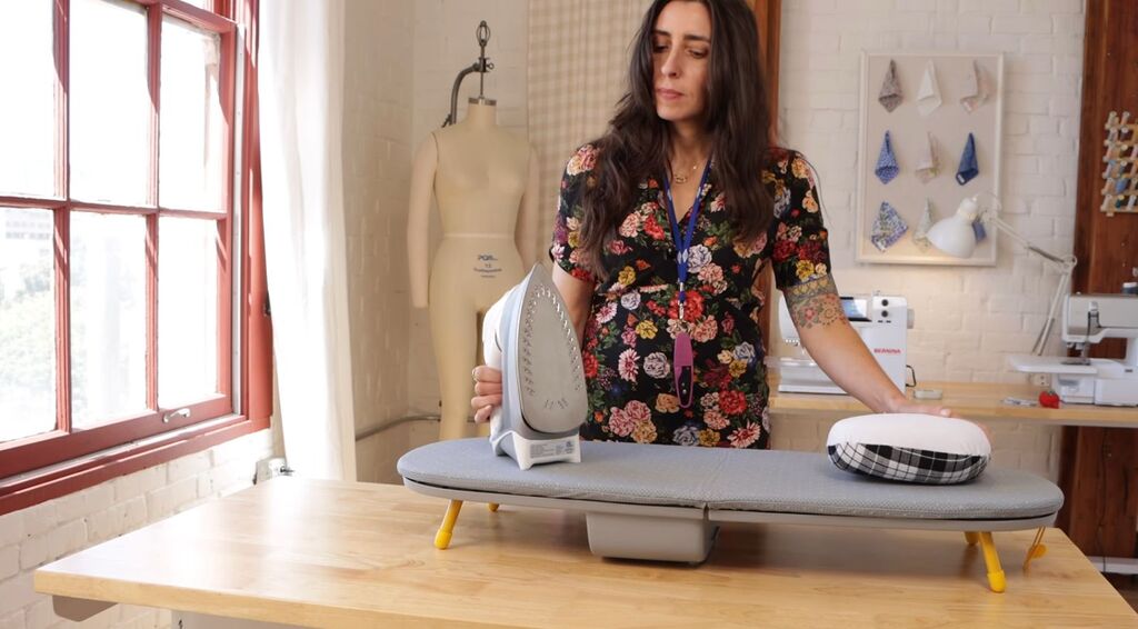 Sarai turning on iron at the start of a sewing session