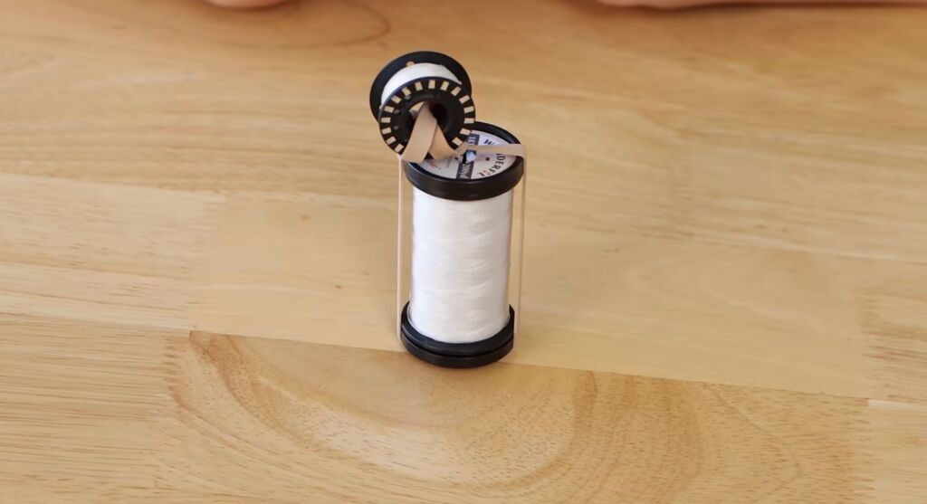 bobbin wound with specialty thread, rubber-banded to its matching spool