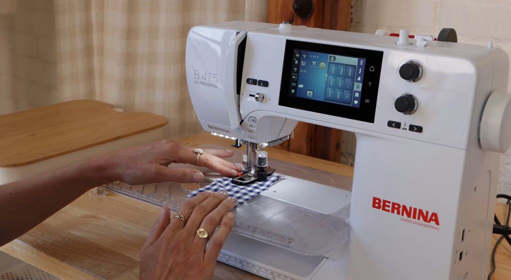 A small fabric test scrap sitting next to a sewing machine, ready to use
