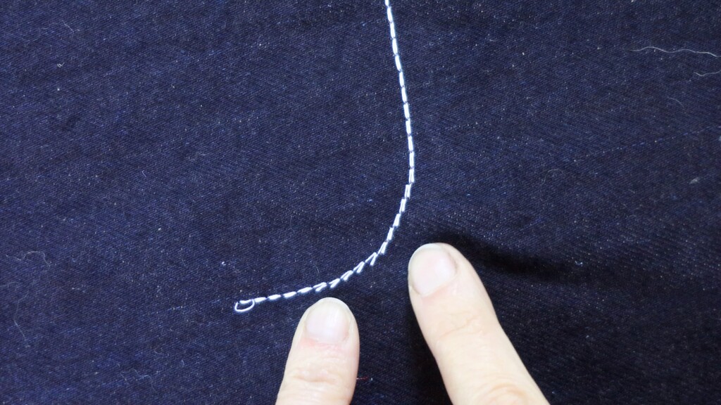 Close-up of the triple stitch struggling around a curved seam, like the fly, before correction