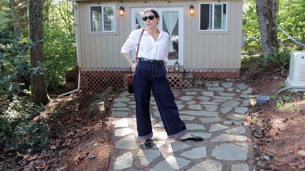 Full-length shot of the finished Noah jeans, uncuffed, worn with a simple top